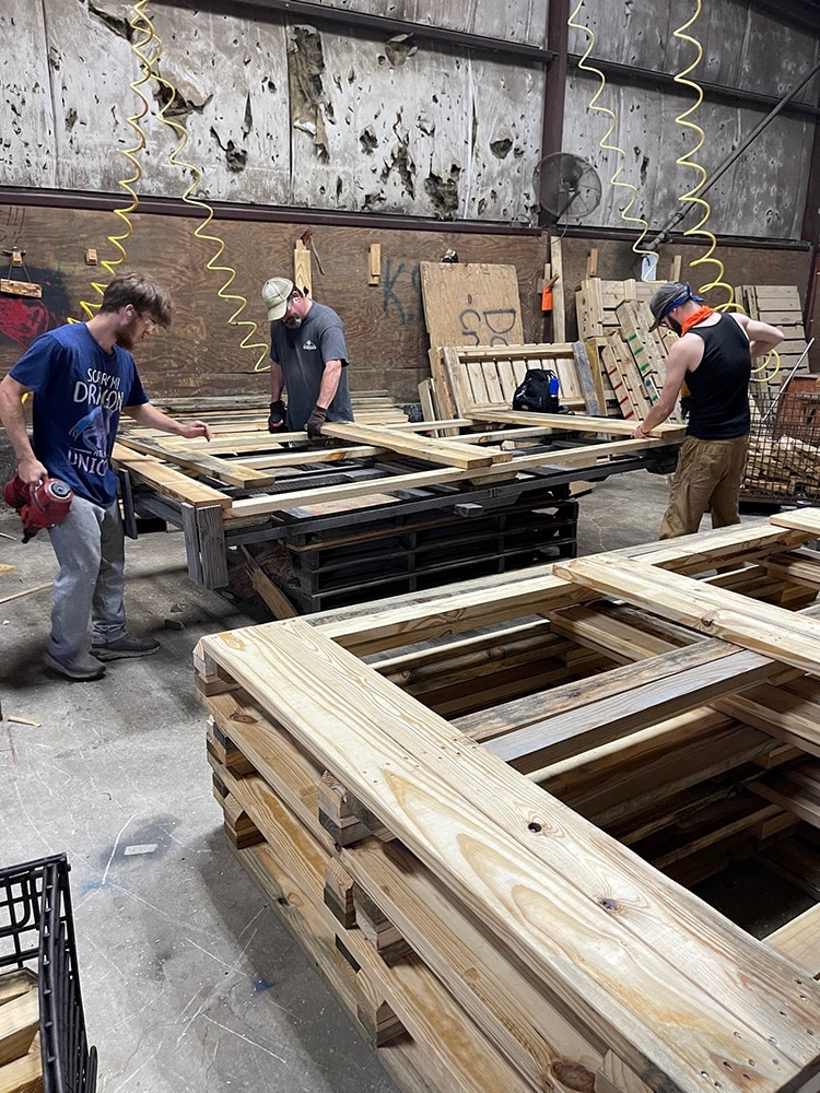 Valley Pallet and Crating team building 104x44 skids in their manufacturing facility.