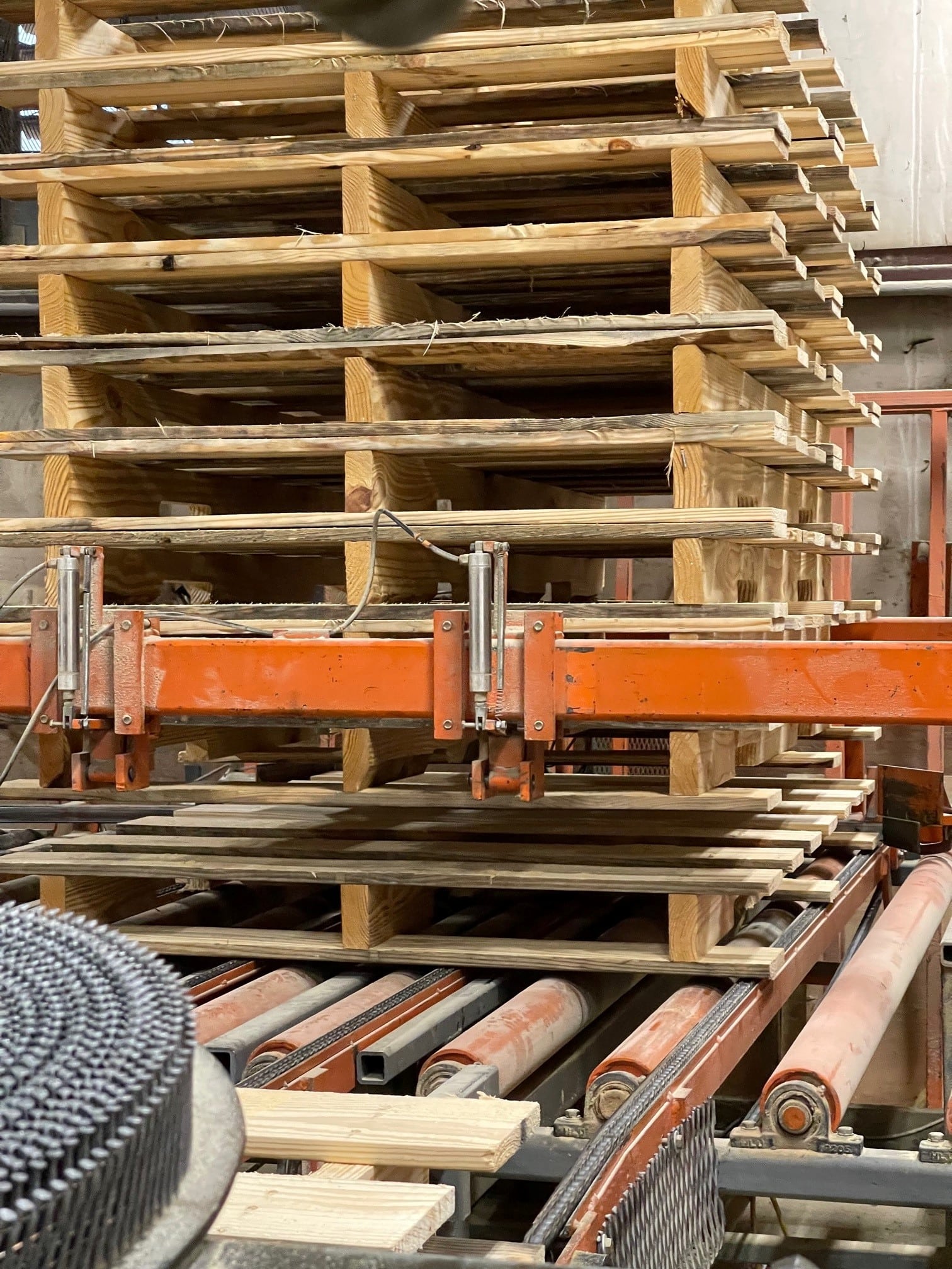 Custom pallets being cut to specific sizes on manufacturing equipment inside Valley Pallet and Crating manufacturing plant.