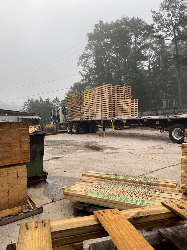 Loading up Valley Pallet and Crating truck with skids, pallets, and crates to deliver to customers.