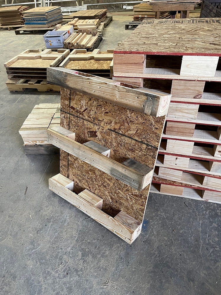 Wood blocking under skid to show how skids are elevated off of the floor in Valley Pallet and Crating manufacturing facility.