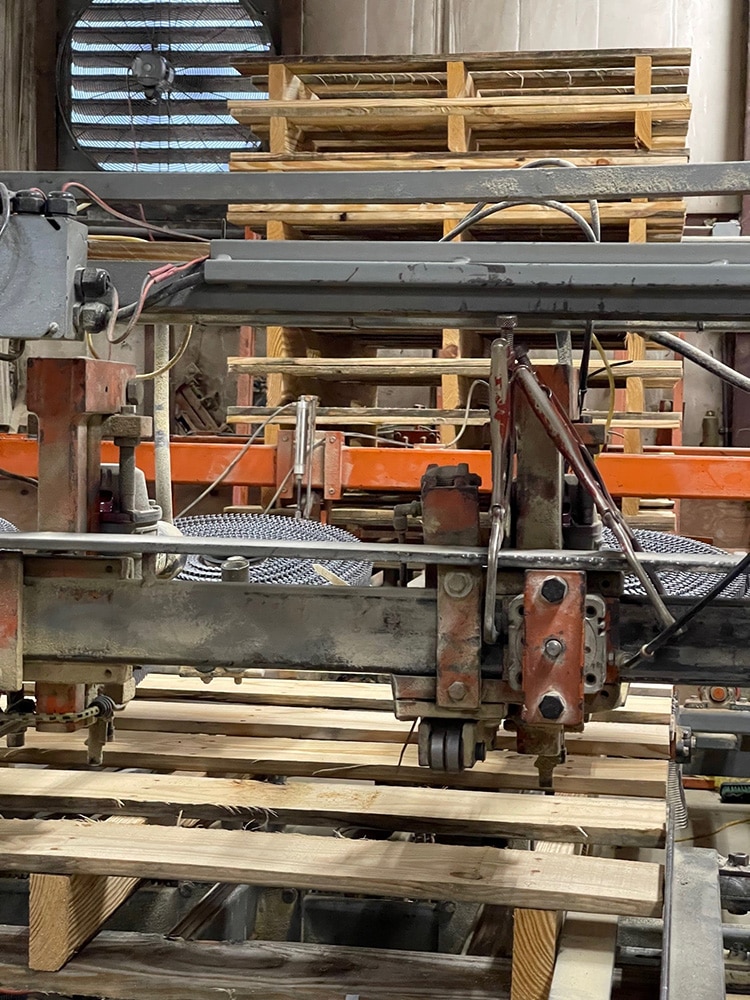 Skids being cut to custom sizes on Valley Pallet and Crating's manufacturing equipment.