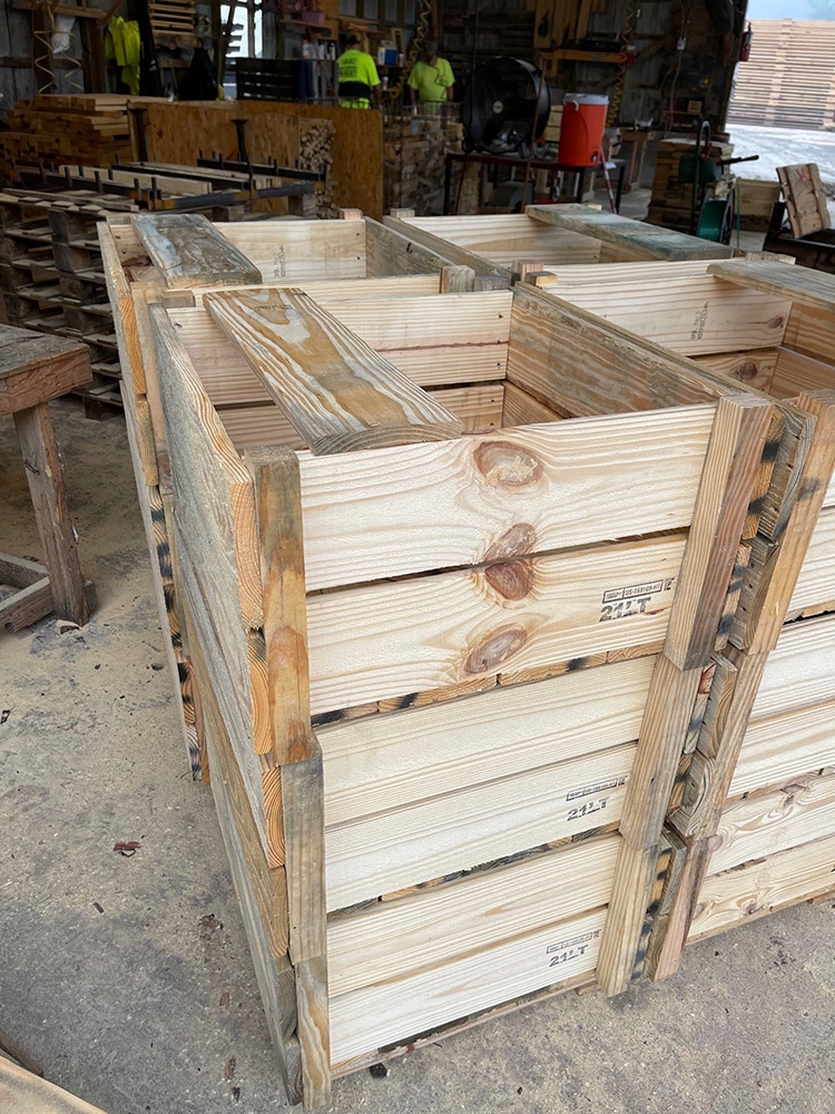 Custom crates are being built and stacked for transportation and warehouse solutions.