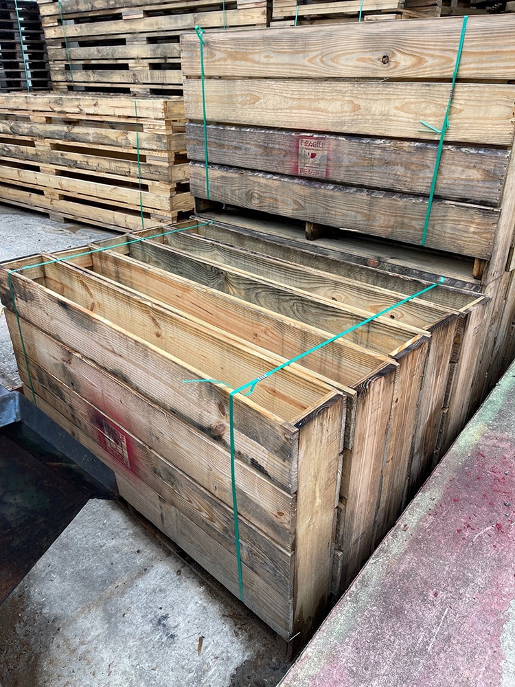 Multiple wooden pallets bound together for easy transport from Valley Pallet and Crating facility.